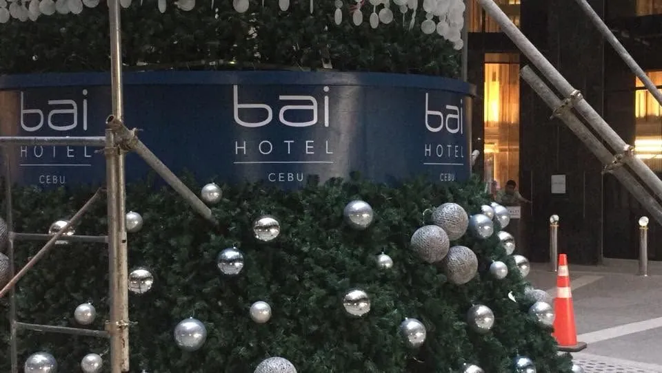 MCAV crew installing a Bai Hotel Cebu tarpaulin at Bai Hotel Cebu