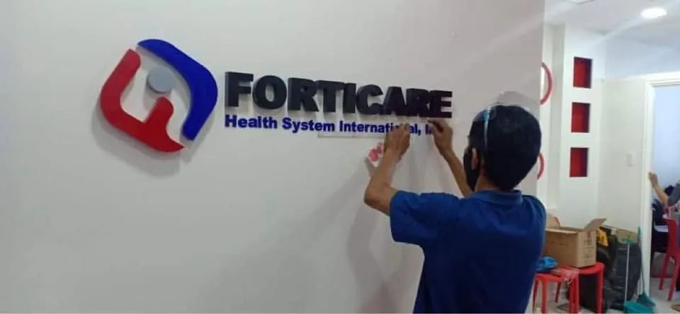 MCAV crew installing a Forticare Health System International, Inc. acrylic built-up letters