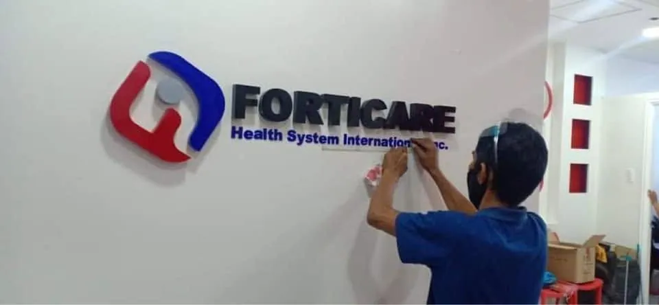 MCAV crew installing a Forticare Health System International, Inc. acrylic built-up letters
