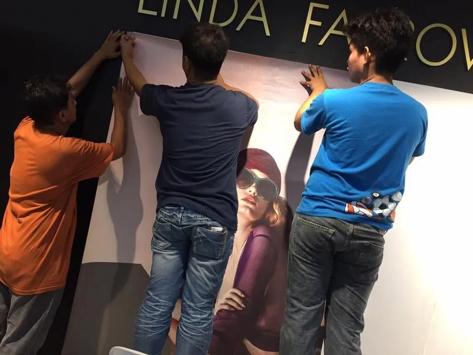 MCAV crew installing a Linda Farrow vinyl graphics