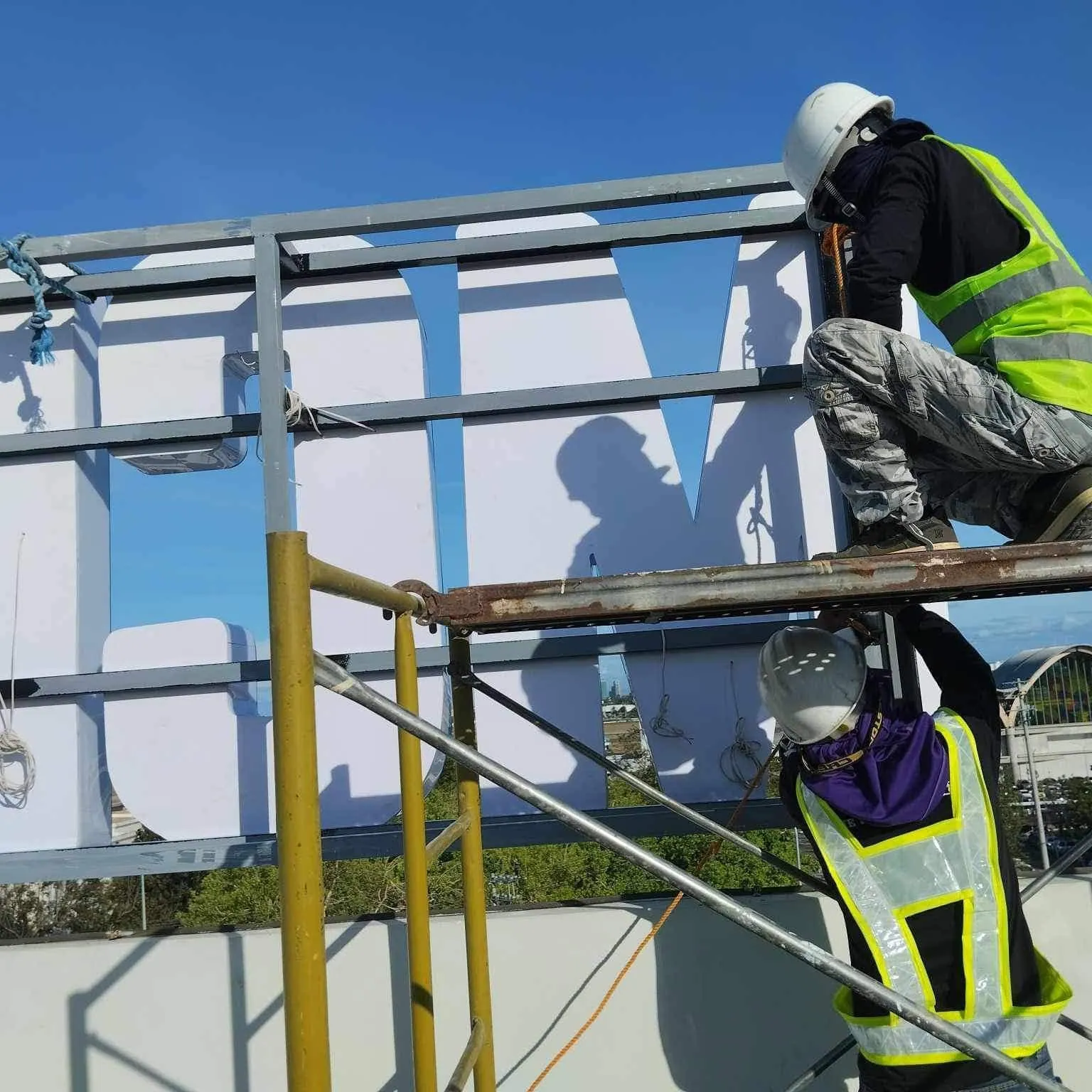 MCAV crew installing a MCIAA acrylic built-up letters