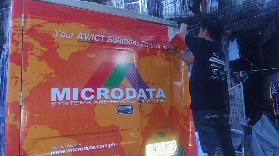 MCAV crew installing a Microdata Systems and Management, Inc. vehicle wrap