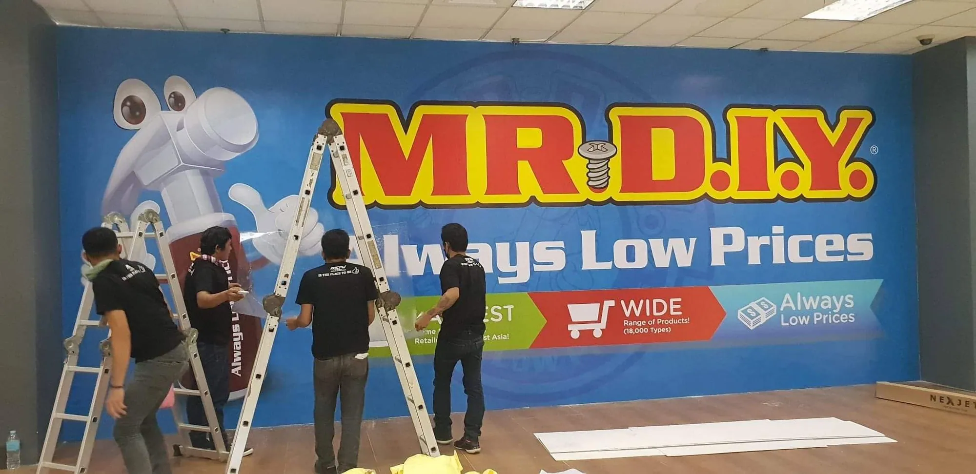 MCAV crew installing a Mr. D.I.Y. vinyl graphics