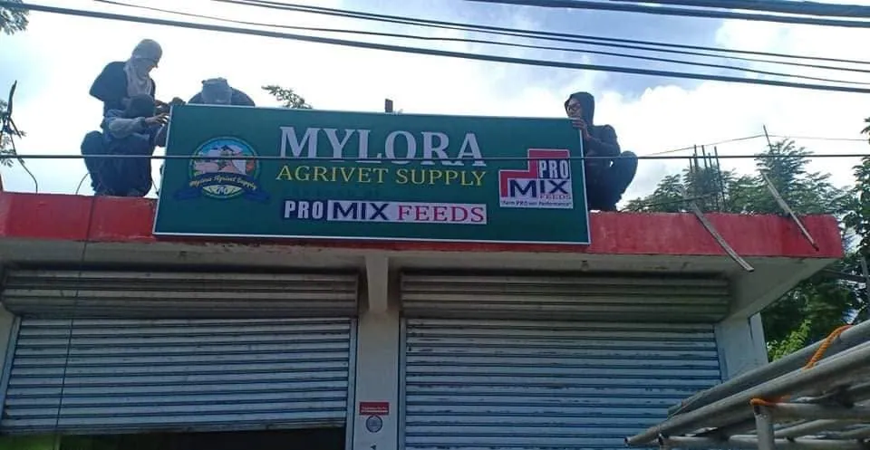MCAV crew installing a Mylora Agrivet Supply Panaflex sign