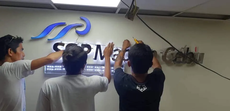 MCAV crew installing a SSP Mactan Cebu lighted sign